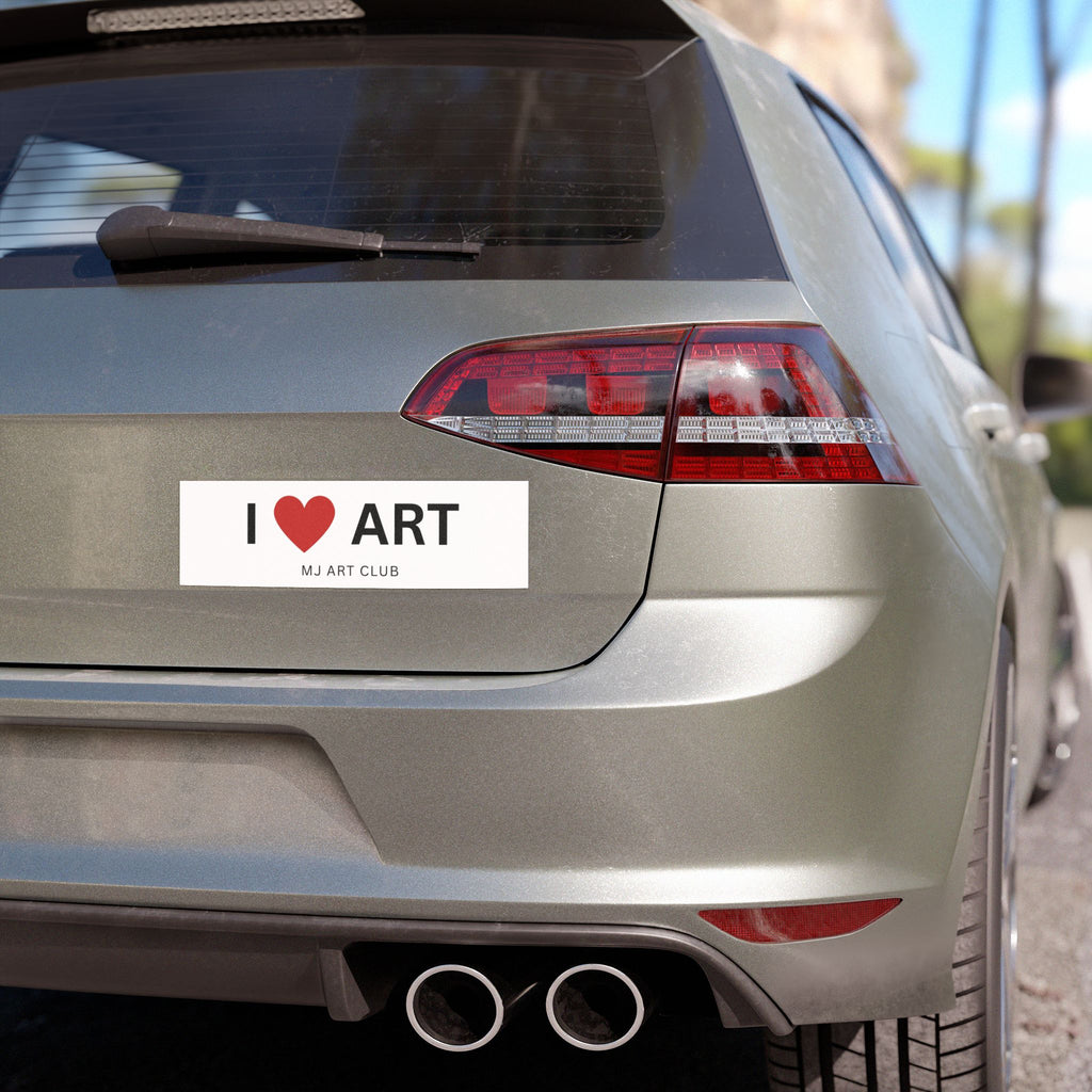 Car's rear bumper with a humorous bumper sticker on a street background