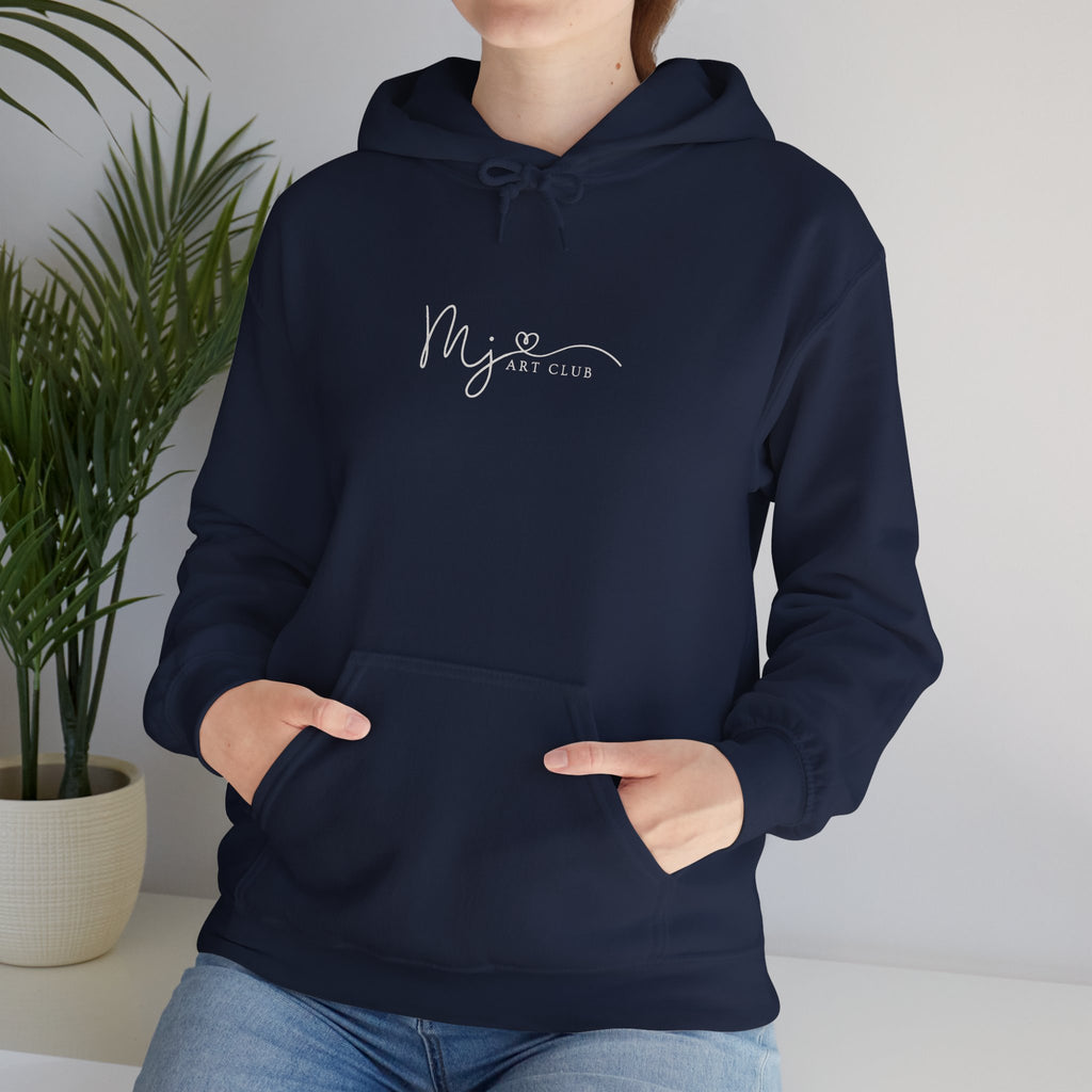 Person wearing a navy blue hoodie with a plant in the background