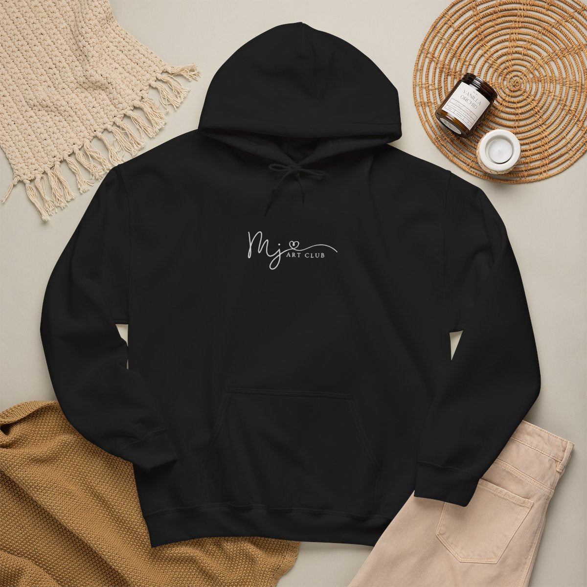 Black hoodie with 'MJ art club' text on a neutral background