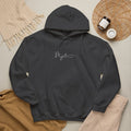 Black hoodie with 'MJ art club' text on a neutral background