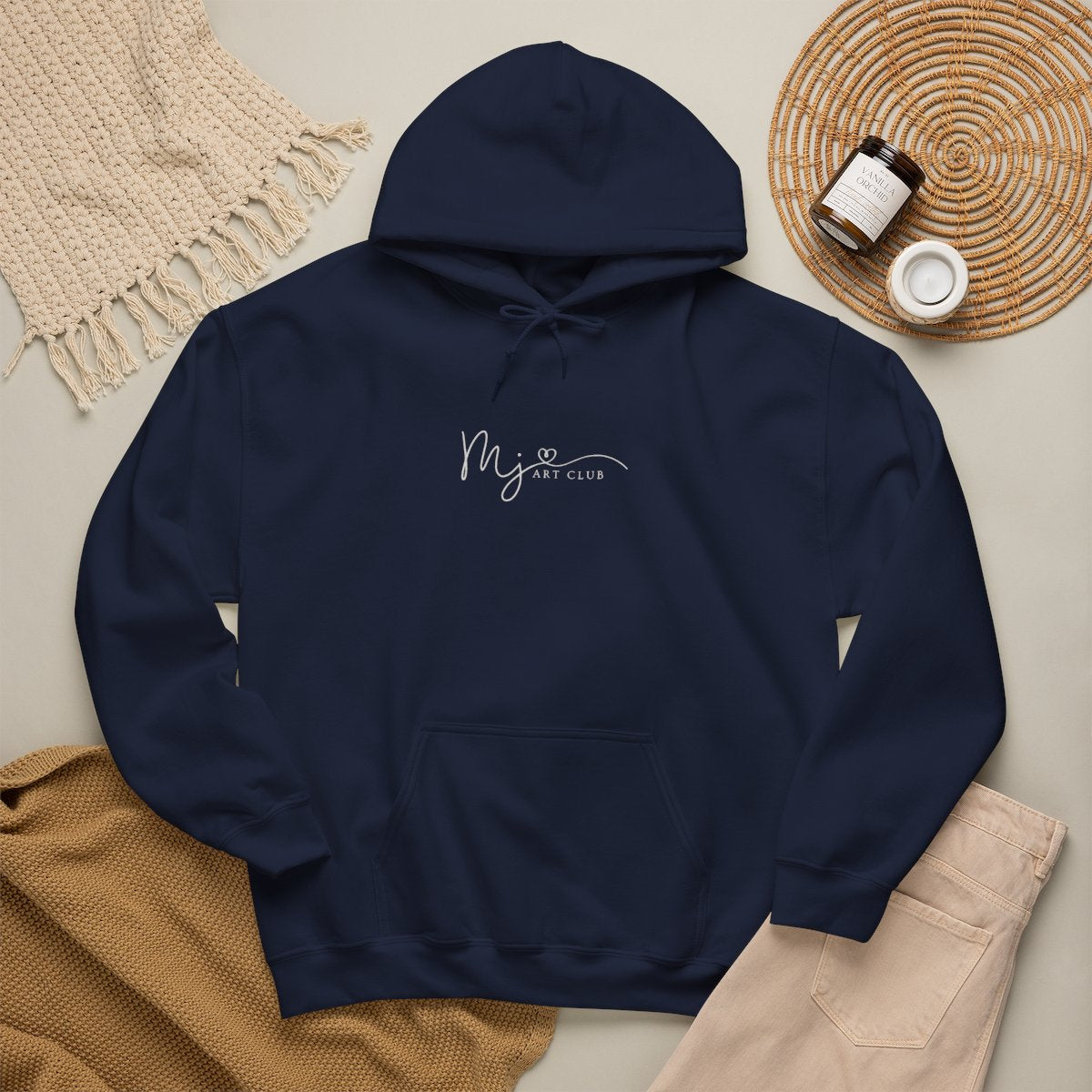 Blue hoodie with 'MJ art club' text on a neutral background