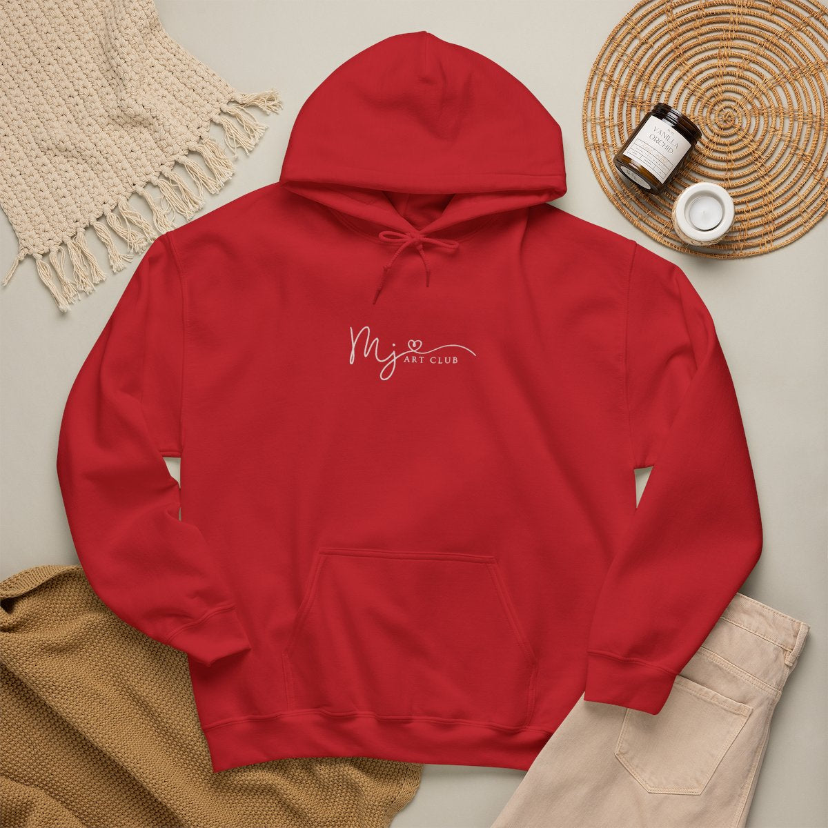 Red hoodie with 'MJ art club' text on a neutral background