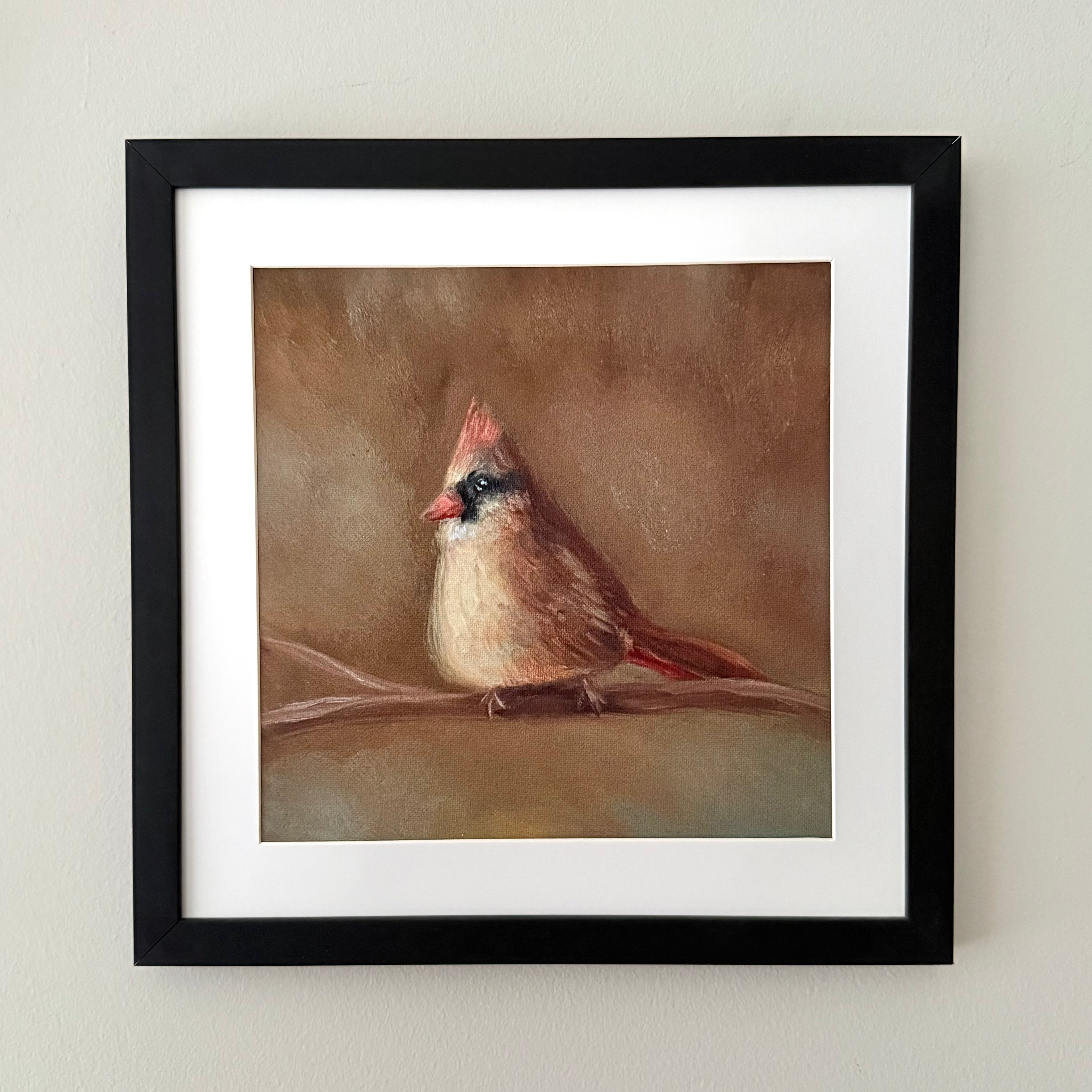 Black frame with white matting including a fine art print of a female cardinal on a branch with a brown bokeh background