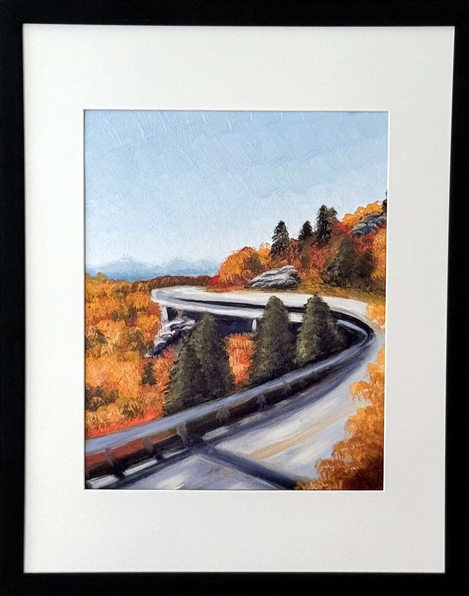 Framed art print of a mountain road featuring fall foliage.