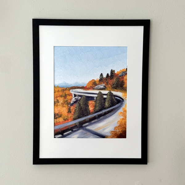Framed art print of a mountain road featuring fall foliage.