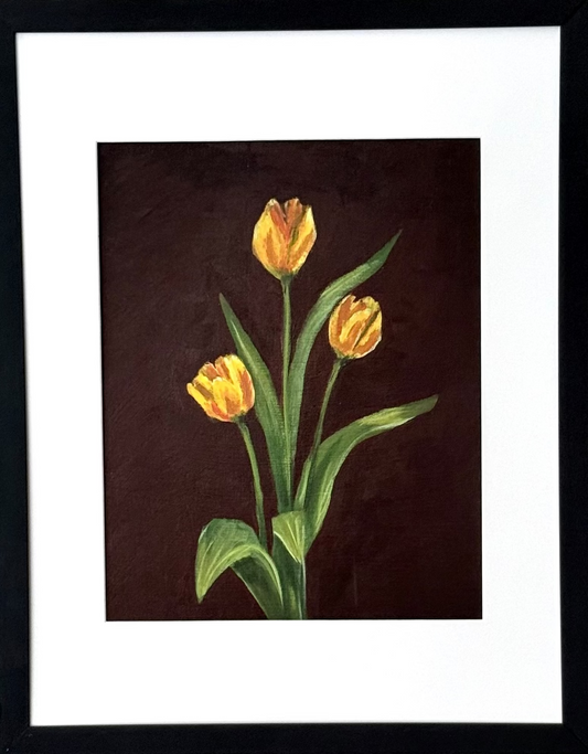 Framed art print of three yellow tulips on a brown background. 