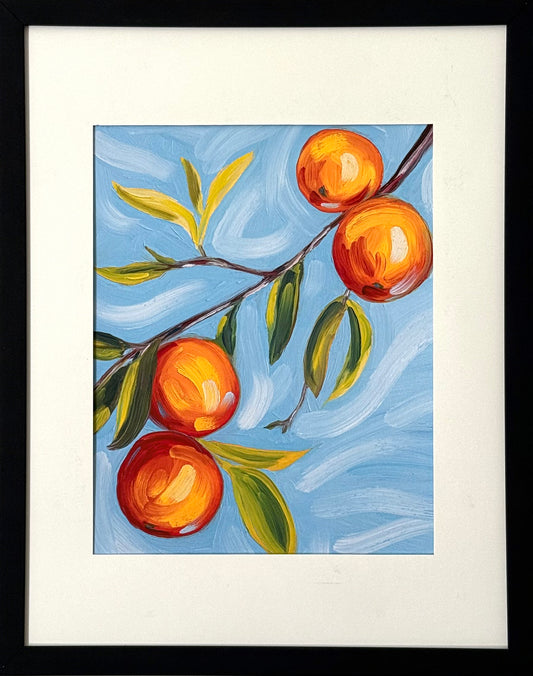 Print of a painting of an orange tree branch in a black frame 