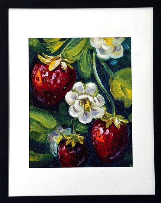 Print of a painting of three strawberries framed against a white wall