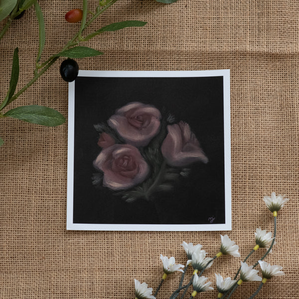 Burlap background with various floral decorations surrounding a fine art print depicting pink roses on a brown background