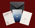 Set of 5x7 cards with swan designs, a letter, and a black envelope on a red background 